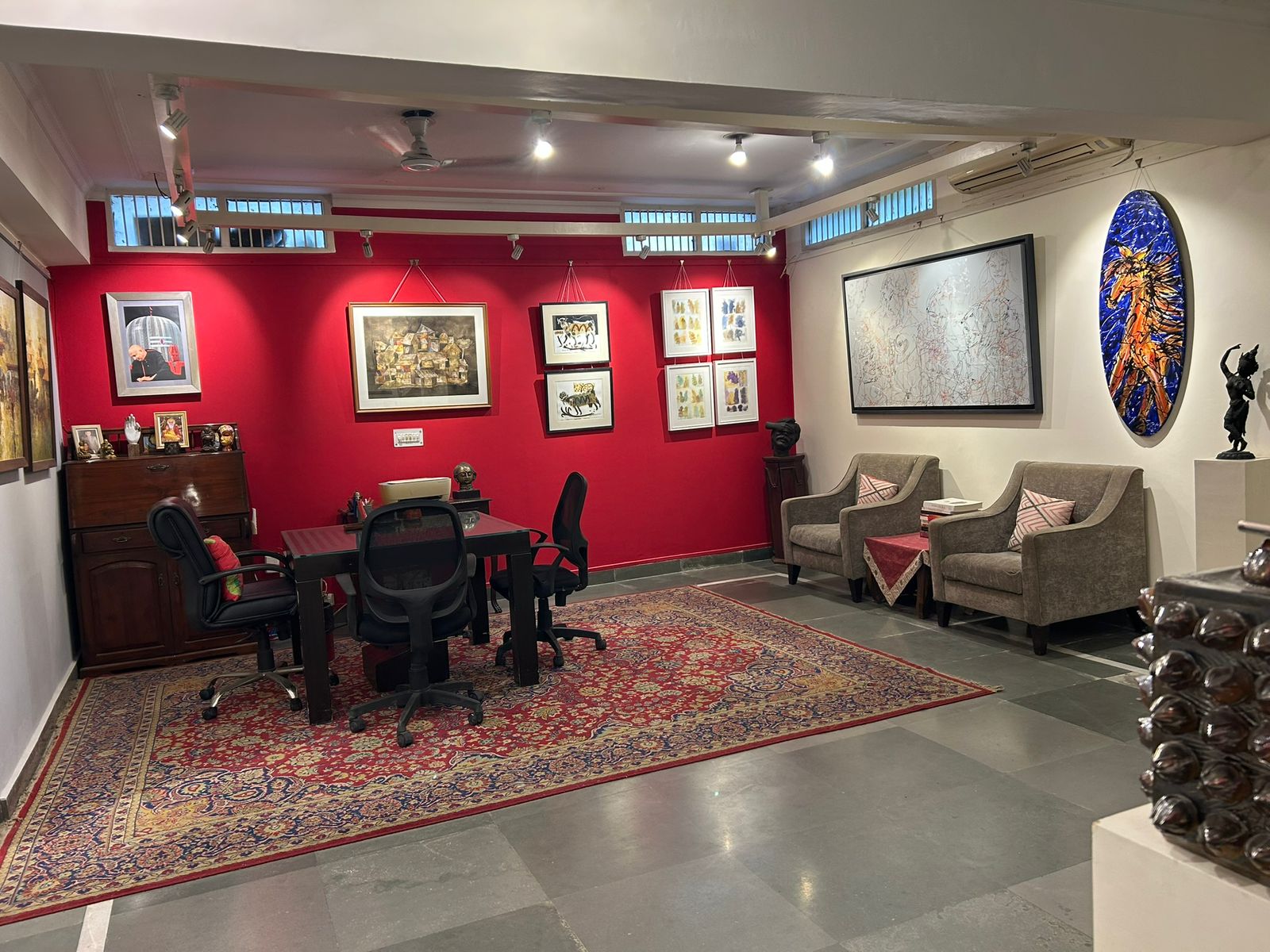 Gallery One — viewing room with seating and curated wall display